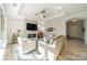 Bright living room featuring a fireplace with mounted TV, stylish furniture, and plenty of natural light at 2014 Newstyle Way, Tega Cay, SC 29708