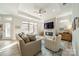 Open-concept living room featuring modern furniture, a fireplace with a mounted TV, and large windows with natural light at 2014 Newstyle Way, Tega Cay, SC 29708