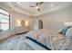 Bright main bedroom featuring a tray ceiling, ceiling fan, and light-colored furnishings, creating a calm atmosphere at 2014 Newstyle Way, Tega Cay, SC 29708
