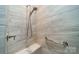 Shower boasts elegant tile, modern fixtures, a convenient bench, and a handrail at 2014 Newstyle Way, Tega Cay, SC 29708