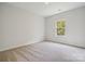 Simple bedroom with carpeted floor and a window at 123 Kepli Way # 12, Mooresville, NC 28115