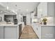 Bright kitchen boasts white cabinets, an island, and stainless steel appliances at 123 Kepli Way, Mooresville, NC 28115