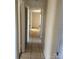 Hallway with tile floors providing access to multiple rooms in a well-lit and functional layout at 1314 Milan Rd, Charlotte, NC 28216