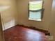 Bedroom featuring a window and wood floors at 1424 Montana Dr, Charlotte, NC 28216