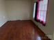 Spacious bedroom featuring wood floors and a bright window at 1424 Montana Dr, Charlotte, NC 28216