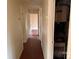 Hallway featuring multiple doors, wood floors, and access to a furnace at 1424 Montana Dr, Charlotte, NC 28216