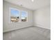 Bright bedroom with neutral carpeting and two large windows at 209 E Warfield Dr, Mooresville, NC 28115