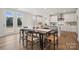 Kitchen and dining area with wooden table, white cabinets, and hardwood floors at 209 E Warfield Dr, Mooresville, NC 28115