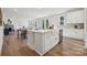 Open kitchen with white cabinets, farmhouse sink, and large island at 209 E Warfield Dr, Mooresville, NC 28115