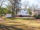 Large backyard with shed and mature trees at 301 S Washington St, Monroe, NC 28112