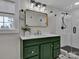 Modern bathroom with green vanity and walk-in shower at 301 S Washington St, Monroe, NC 28112