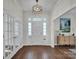 Elegant entryway with hardwood floors, a chandelier, and French doors at 301 S Washington St, Monroe, NC 28112