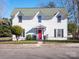 Two-story white house with a red door and black fence at 301 S Washington St, Monroe, NC 28112