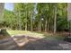 Private backyard with a patio and mature trees at 5731 Brookhaven Rd, Charlotte, NC 28210