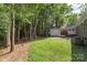 Spacious backyard with detached shed and wooded area at 5731 Brookhaven Rd, Charlotte, NC 28210