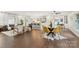 Bright dining area with hardwood floors and stylish yellow chairs at 5731 Brookhaven Rd, Charlotte, NC 28210