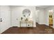 Light and bright entryway with hardwood floors and a gold console table at 5731 Brookhaven Rd, Charlotte, NC 28210