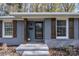 Brick ranch home with gray paint, wood shutters, and landscaping at 5731 Brookhaven Rd, Charlotte, NC 28210