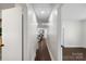 Long hallway with dark hardwood floors and white walls at 5731 Brookhaven Rd, Charlotte, NC 28210