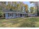 Newly renovated gray house with shutters and front yard at 5731 Brookhaven Rd, Charlotte, NC 28210