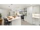 Modern kitchen with white cabinets, marble backsplash, and island at 5731 Brookhaven Rd, Charlotte, NC 28210