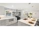 Modern kitchen with white cabinets, marble backsplash, and large island at 5731 Brookhaven Rd, Charlotte, NC 28210