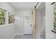 Laundry room with barn door, window, and tile floor at 5731 Brookhaven Rd, Charlotte, NC 28210