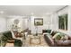 Living room features a brown leather couch and a large window at 5731 Brookhaven Rd, Charlotte, NC 28210