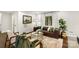 Cozy living room with brown leather sofa and large window at 5731 Brookhaven Rd, Charlotte, NC 28210