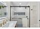 Clean and bright shower with marble walls and hexagon tile floor at 5731 Brookhaven Rd, Charlotte, NC 28210