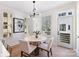 Elegant dining area with modern lighting, a round table, and large windows at 2031 Belmont Terraces Ln # 6, Charlotte, NC 28205