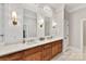 Bathroom with double vanity, wood cabinets, and quartz countertops at 4813 Cambridge Crescent Dr, Charlotte, NC 28226