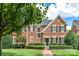 Brick two-story home with manicured lawn and walkway at 4813 Cambridge Crescent Dr, Charlotte, NC 28226