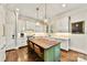 Bright kitchen featuring an island with seating and hardwood floors at 4813 Cambridge Crescent Dr, Charlotte, NC 28226