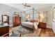 Main bedroom with canopy bed, hardwood floors, and ample natural light at 4813 Cambridge Crescent Dr, Charlotte, NC 28226