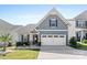 Two-story home with gray siding, white trim, and a two-car garage at 50143 Robins Nest Ln, Lancaster, SC 29720