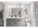 Bathroom featuring double sink vanity with marble countertop and tile shower at 7059 Duncan Acres Dr, Belmont, NC 28012