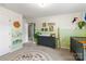 View of staged Bedroom featuring neutral paint, animal themed decor, crib, dresser changing table, and accent rug at 7059 Duncan Acres Dr, Belmont, NC 28012