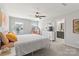 Bright bedroom featuring neutral walls, ceiling fan, and ensuite bathroom at 7059 Duncan Acres Dr, Belmont, NC 28012