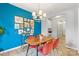 Dining room with bright blue accent wall, modern chandelier, and adjacent office space at 7059 Duncan Acres Dr, Belmont, NC 28012