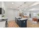 Modern kitchen features white countertops, a navy island, and seamless flow into the open-concept living space at 7059 Duncan Acres Dr, Belmont, NC 28012