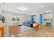 Bright living room with wood floors, neutral walls, modern furniture, and views from the windows at 7059 Duncan Acres Dr, Belmont, NC 28012