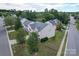 Aerial shot of a charming home nestled in a serene neighborhood with mature trees and well-maintained lawns at 7206 Sandown Ct, Harrisburg, NC 28075