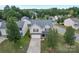 Stunning aerial view of a two-story home featuring a spacious driveway, manicured lawn, and charming neighborhood setting at 7206 Sandown Ct, Harrisburg, NC 28075