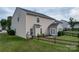 Fenced backyard featuring a cozy patio with seating, perfect for outdoor relaxation and entertaining, with lush green lawn at 7206 Sandown Ct, Harrisburg, NC 28075