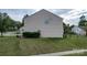 Beige two-story house featuring a well-maintained lawn and simple landscaping, offering a serene backyard space at 7206 Sandown Ct, Harrisburg, NC 28075