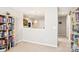 Bright hallway with built-in bookcases and neutral walls at 7206 Sandown Ct, Harrisburg, NC 28075