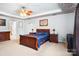 Main bedroom with a wooden sleigh bed and ceiling fan at 7206 Sandown Ct, Harrisburg, NC 28075