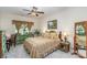 Comfortable bedroom with a ceiling fan, warm natural light, and charming window treatments at 10080 Highland Creek Cir, Indian Land, SC 29707