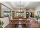 The dining room's large mirror reflects light, highlighting the hardwood floors and furniture at 10080 Highland Creek Cir, Indian Land, SC 29707